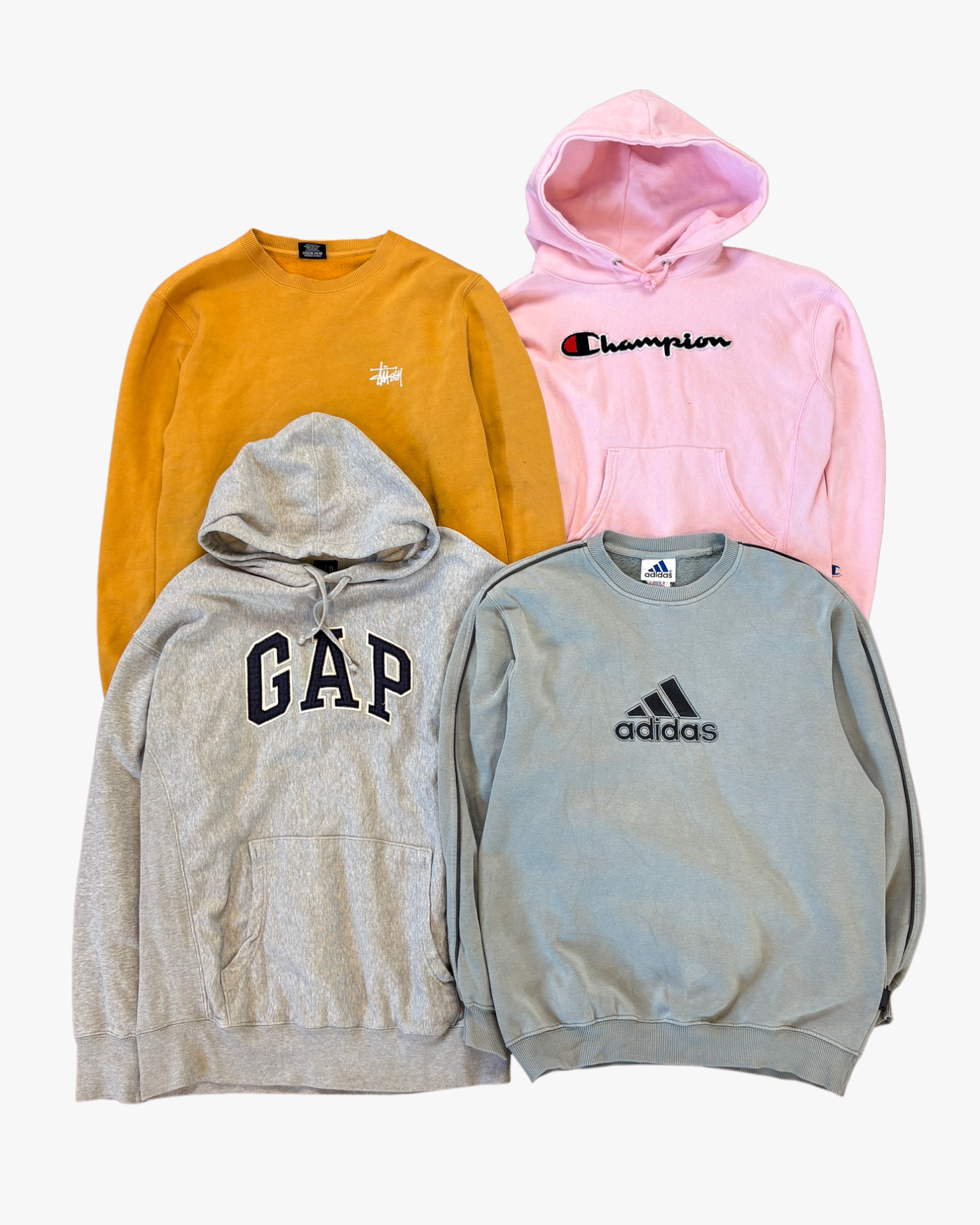 Four hoodies from different brands on a white background